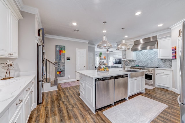 kitchen featuring wall chimney exhaust hood, stainless steel appliances, sink, and white cabinets