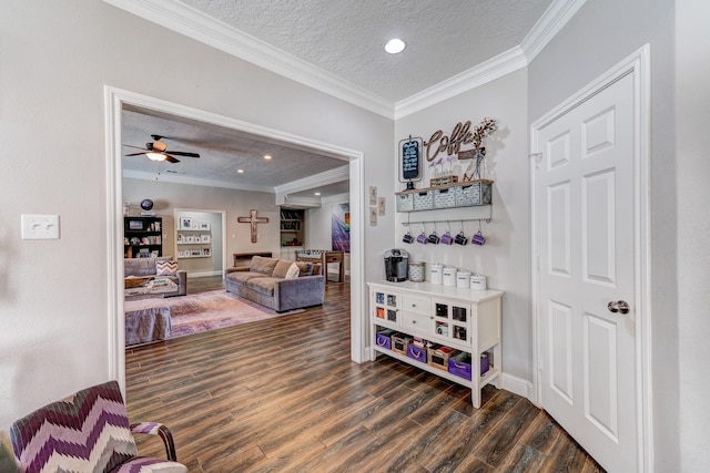 hallway with ornamental molding, dark hardwood / wood-style floors, and a textured ceiling