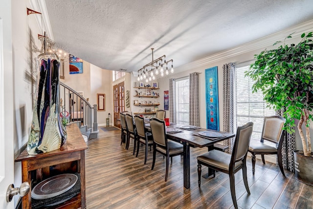 dining space featuring crown molding, a chandelier, dark hardwood / wood-style floors, and a textured ceiling