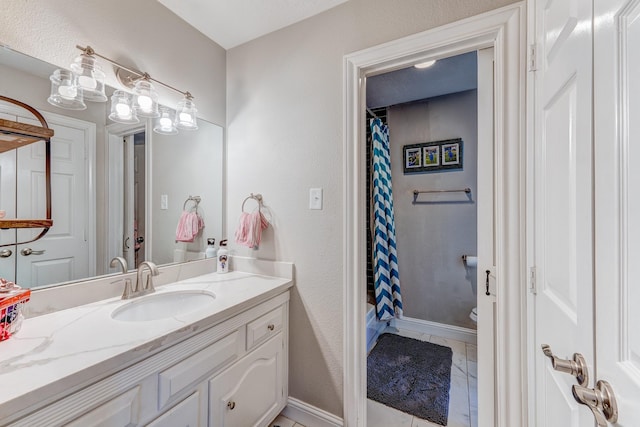 bathroom with a shower with curtain, vanity, tile patterned floors, and toilet