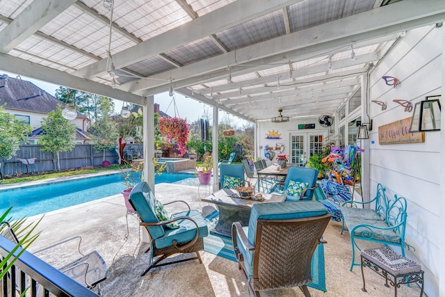 view of patio / terrace with a fenced in pool, a pergola, and french doors