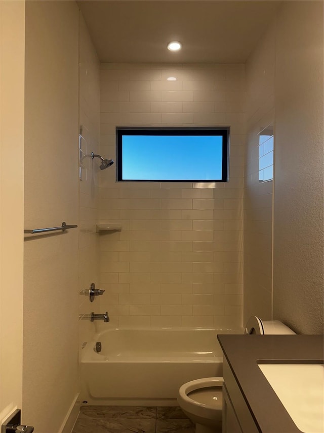 full bathroom featuring tiled shower / bath combo, vanity, a healthy amount of sunlight, and toilet