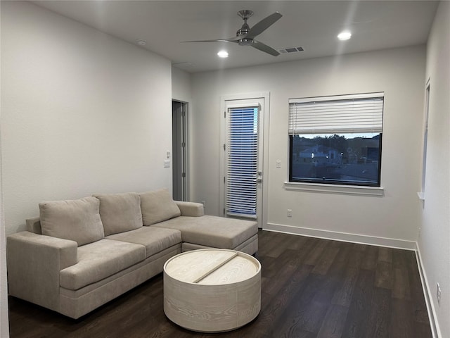 living room with dark wood-type flooring and ceiling fan