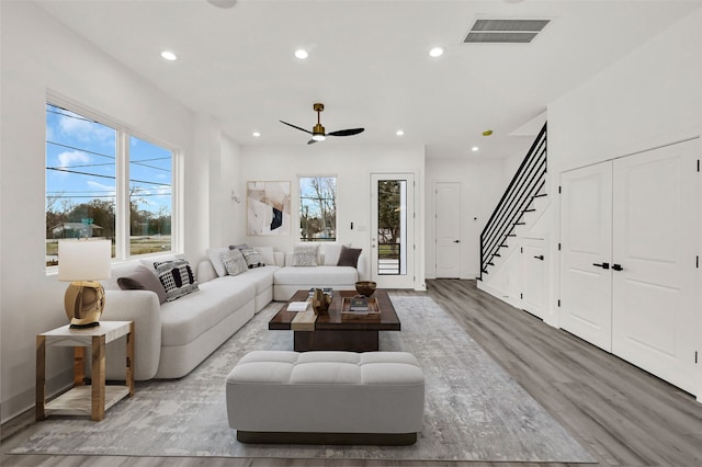 living room with hardwood / wood-style floors and ceiling fan