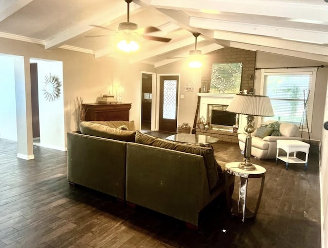 living room with vaulted ceiling with beams, crown molding, dark hardwood / wood-style flooring, ceiling fan, and a fireplace