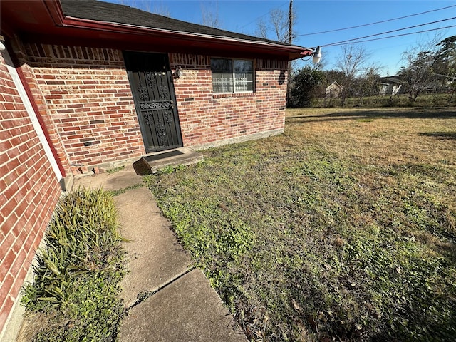 entrance to property with a yard