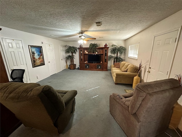 living room with a textured ceiling, ceiling fan, and carpet