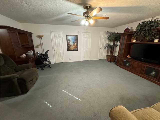 living room featuring ceiling fan, carpet, and a textured ceiling