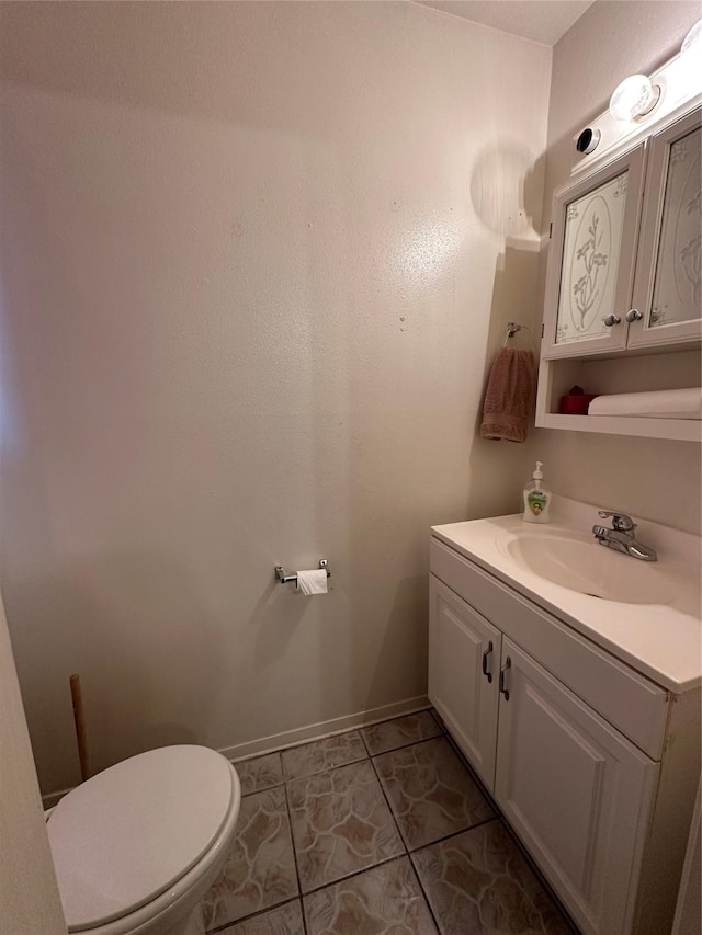 bathroom with vanity, tile patterned flooring, and toilet