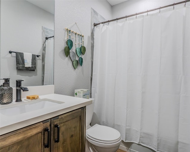 bathroom with vanity, toilet, and curtained shower