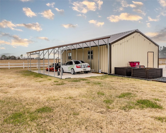 view of outdoor structure with a yard and a carport