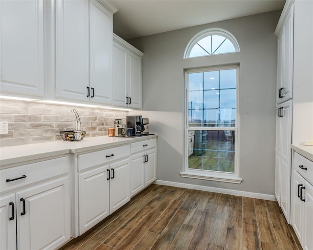 bar with white cabinetry, dark hardwood / wood-style flooring, and decorative backsplash