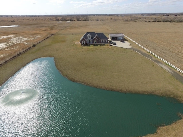 birds eye view of property featuring a water view and a rural view