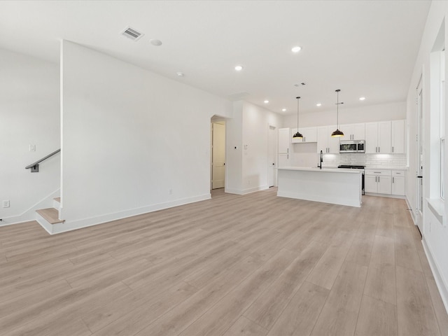 unfurnished living room featuring light hardwood / wood-style flooring