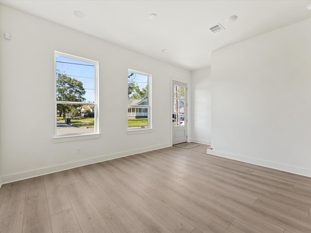 spare room featuring light hardwood / wood-style flooring