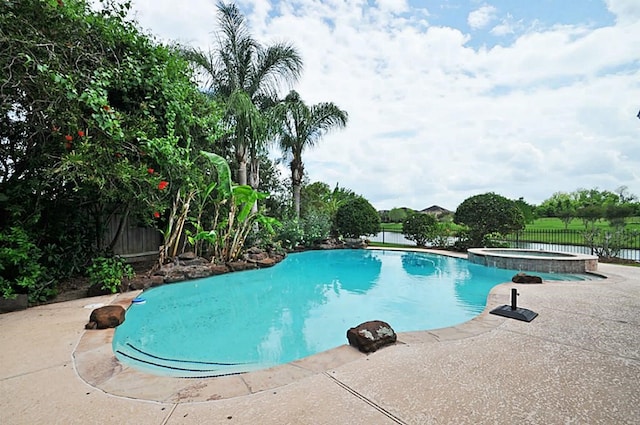 view of swimming pool featuring an in ground hot tub and a patio area