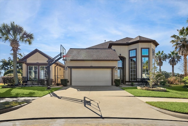 view of front of home with a garage and a front lawn