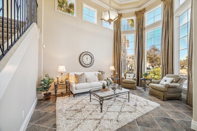 living room featuring ornamental molding and a high ceiling