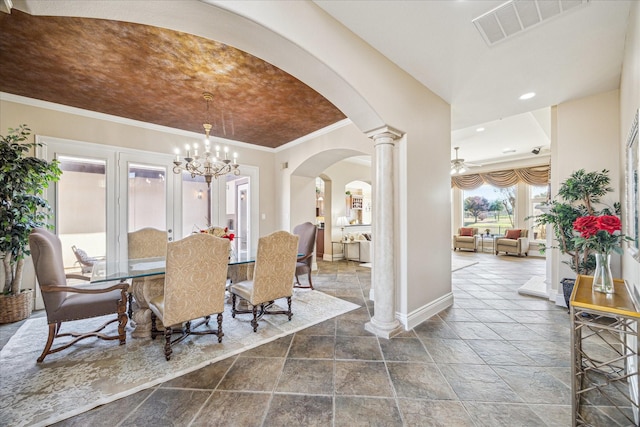 dining room featuring decorative columns, crown molding, and ceiling fan with notable chandelier