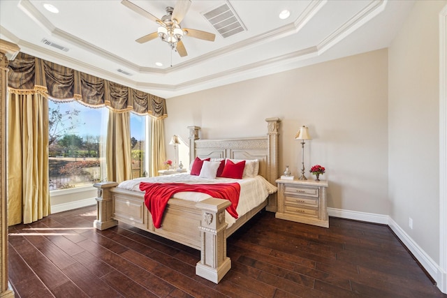 bedroom with dark hardwood / wood-style flooring, ornamental molding, a raised ceiling, and ceiling fan