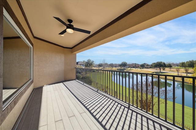 balcony featuring a water view and ceiling fan