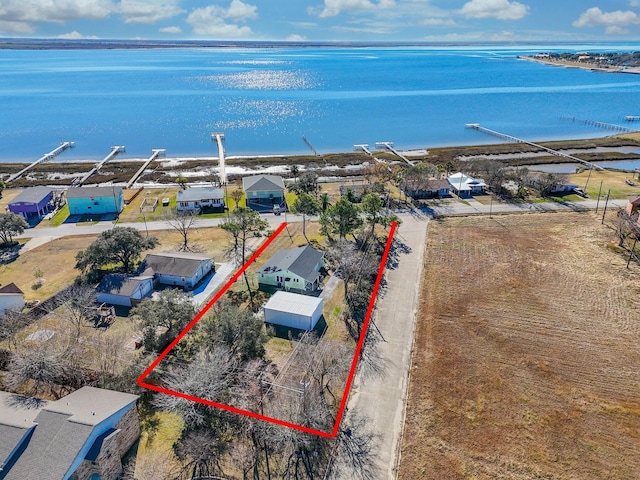 birds eye view of property with a water view