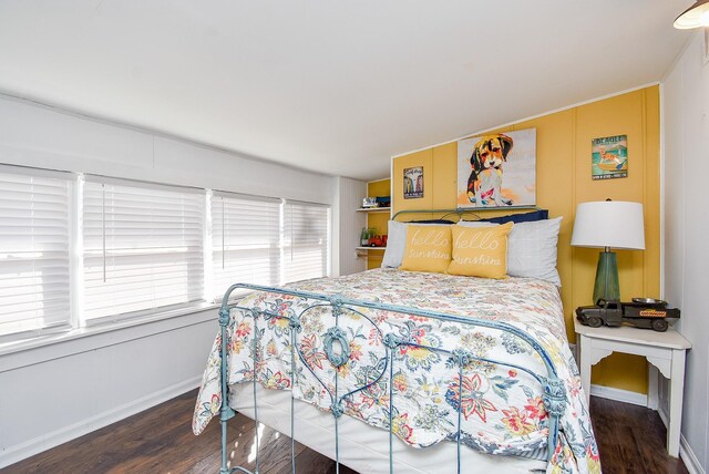 bedroom with dark wood-type flooring