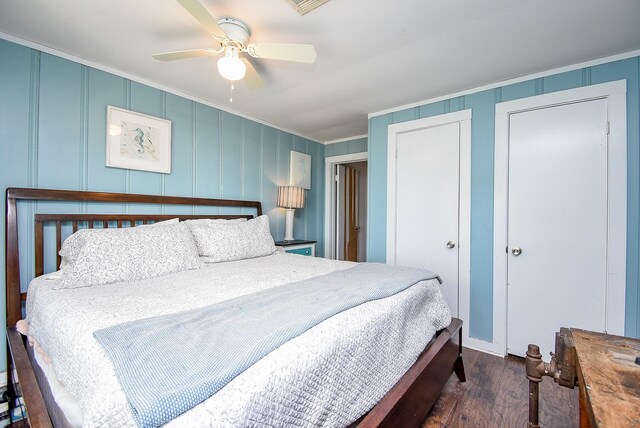 bedroom featuring ceiling fan, ornamental molding, and dark hardwood / wood-style flooring