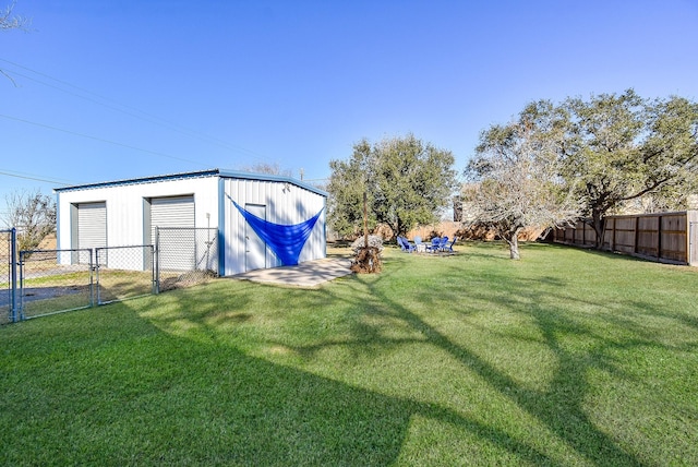 view of yard with a fenced backyard and a detached garage