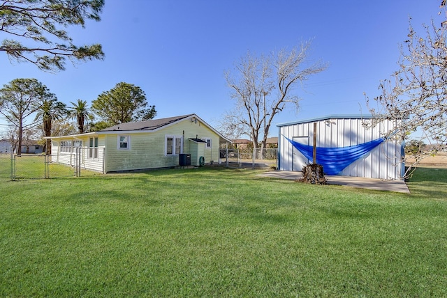 view of yard featuring a gate, fence, and cooling unit