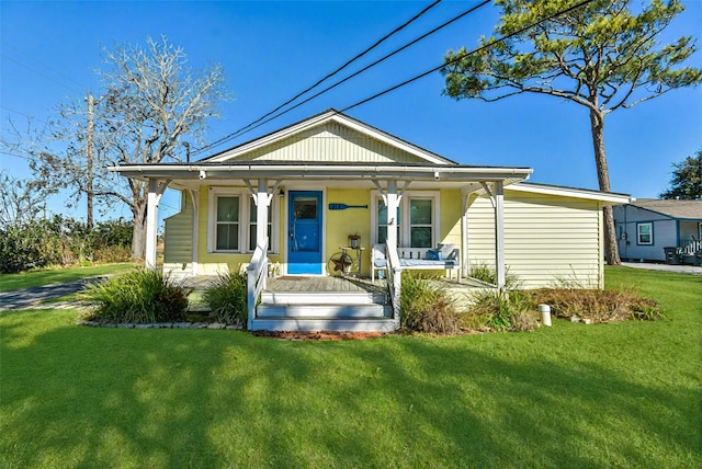 bungalow featuring a front lawn and a porch