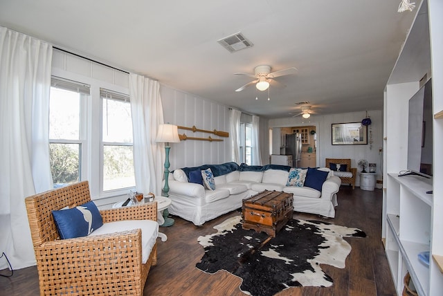 living room featuring ceiling fan and dark hardwood / wood-style flooring