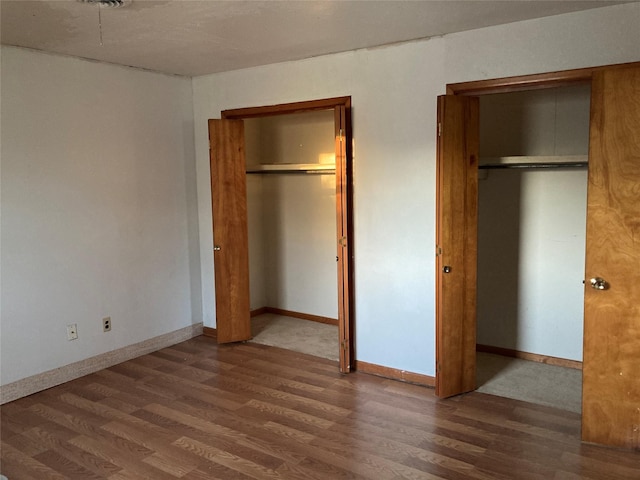 unfurnished bedroom featuring dark wood-type flooring