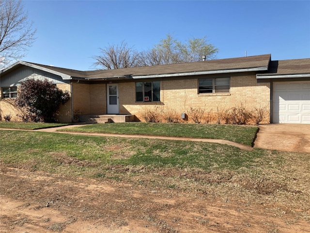 single story home featuring a garage and a front lawn