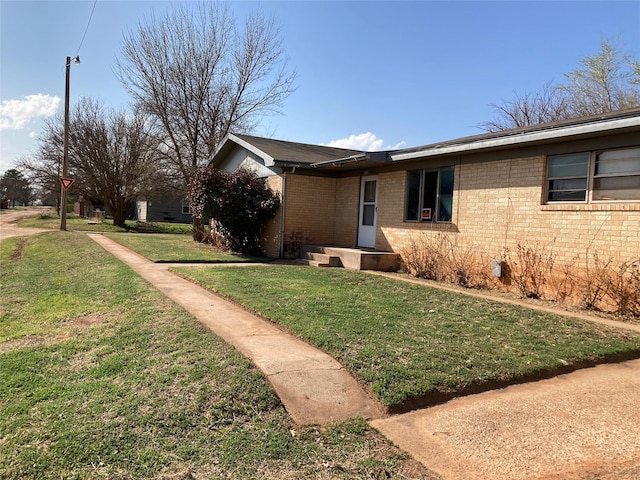 view of side of home with a lawn