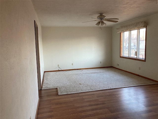 unfurnished room featuring dark hardwood / wood-style flooring and ceiling fan