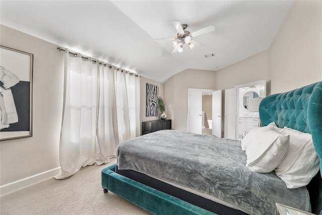 bedroom with ceiling fan, lofted ceiling, connected bathroom, and carpet