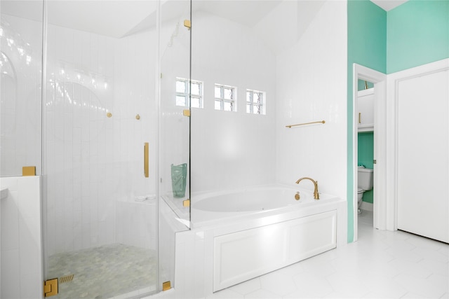 bathroom featuring toilet, tile patterned flooring, and shower with separate bathtub