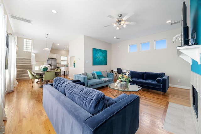 living room with ceiling fan and light hardwood / wood-style floors