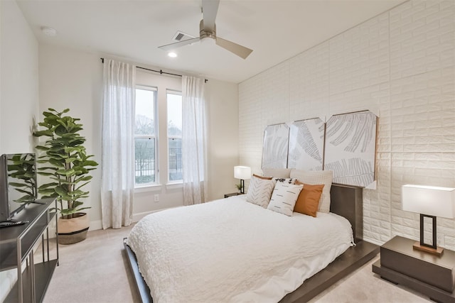 carpeted bedroom featuring ceiling fan, brick wall, and multiple windows