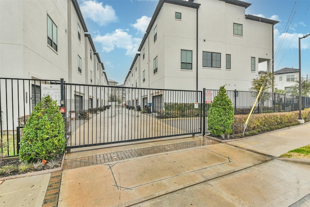 view of gate with a fenced front yard