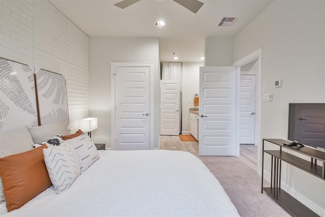 bedroom featuring ceiling fan and ensuite bath