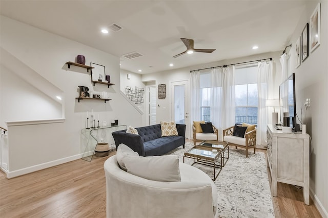 living room with ceiling fan and light hardwood / wood-style floors