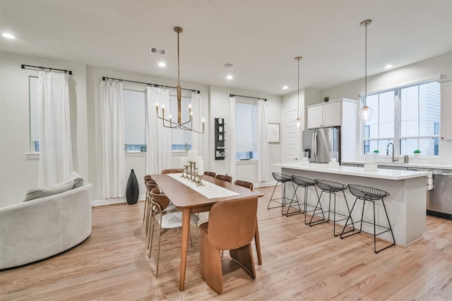 dining room with recessed lighting, visible vents, and light wood finished floors