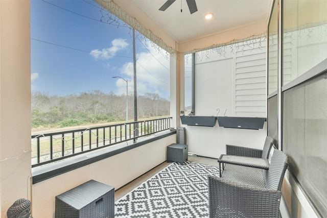 sunroom / solarium featuring ceiling fan and a healthy amount of sunlight