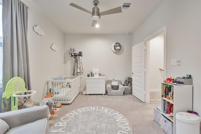 rec room with a ceiling fan, light colored carpet, and visible vents