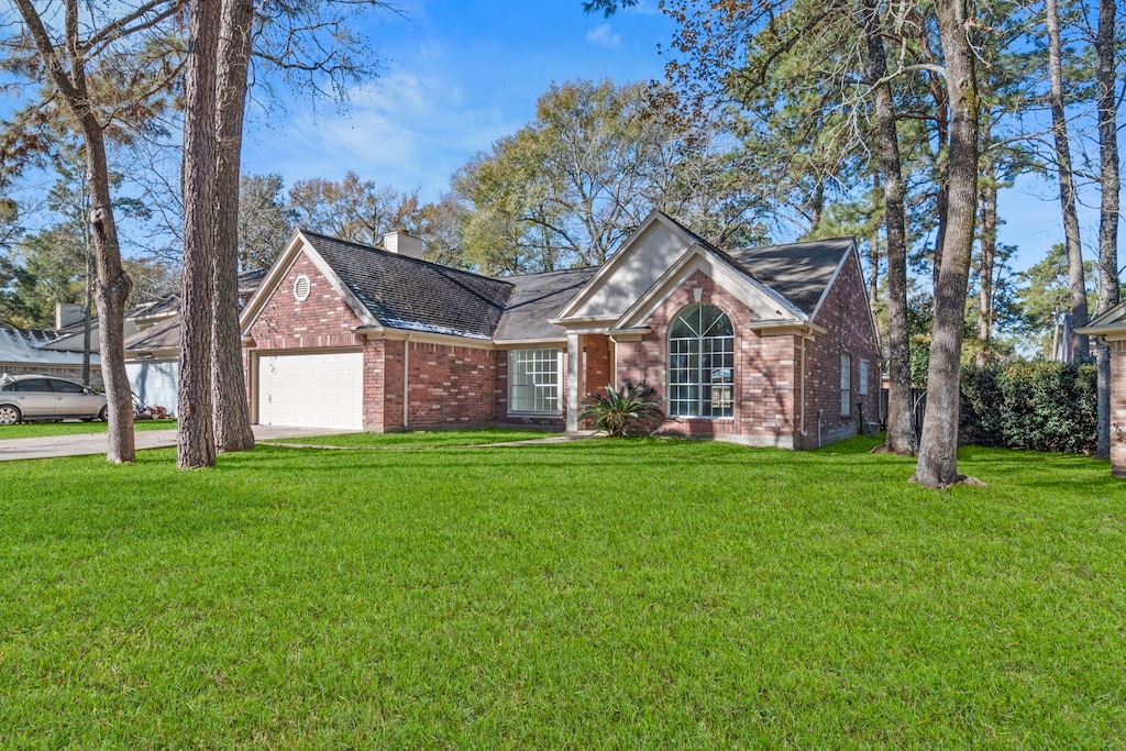 view of front of house with a garage and a front yard