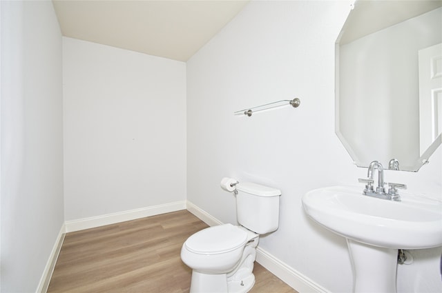 bathroom featuring hardwood / wood-style flooring and toilet