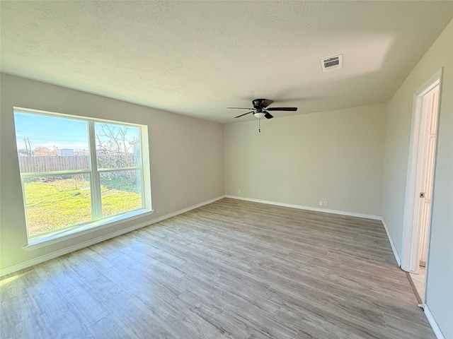 unfurnished room with ceiling fan and light wood-type flooring