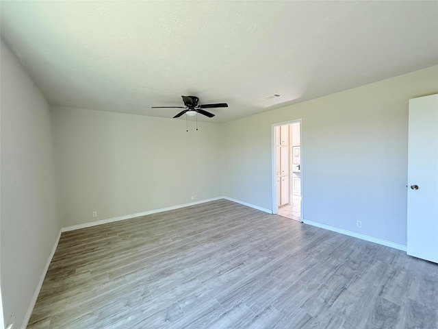 spare room featuring ceiling fan and light hardwood / wood-style flooring